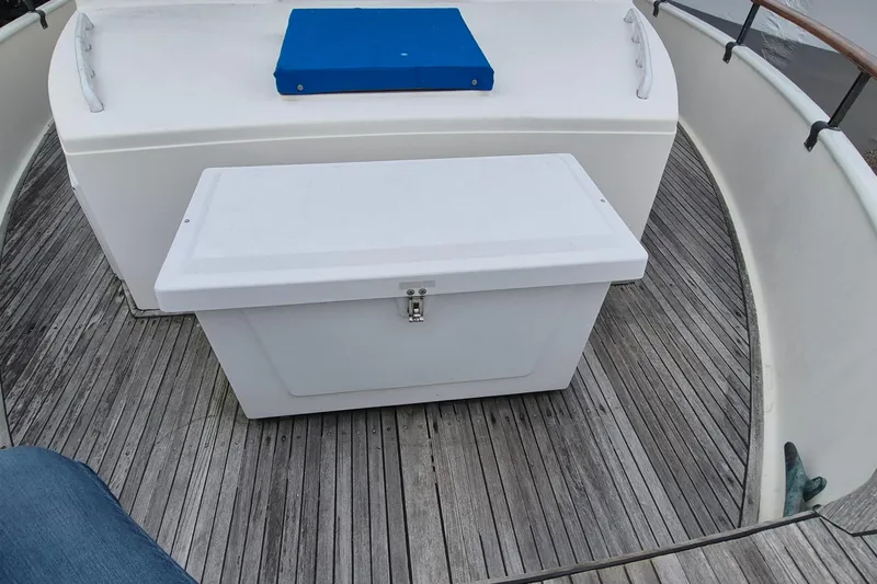 Burnin Daylight Yacht Photos Pics 1983 Grand Banks 42 Classic boat deck with storage box and blue cushion.