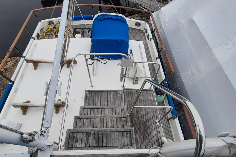 Burnin Daylight Yacht Photos Pics 1983 Grand Banks 42 Classic yacht deck with wooden steps and blue cover.