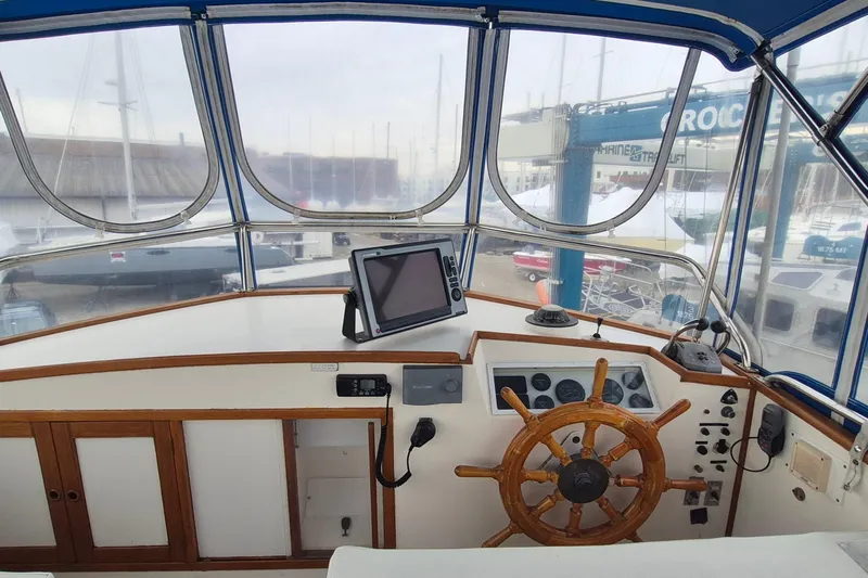 Burnin Daylight Yacht Photos Pics Helm of 1983 Grand Banks 42 Classic yacht with wooden wheel and navigation equipment.