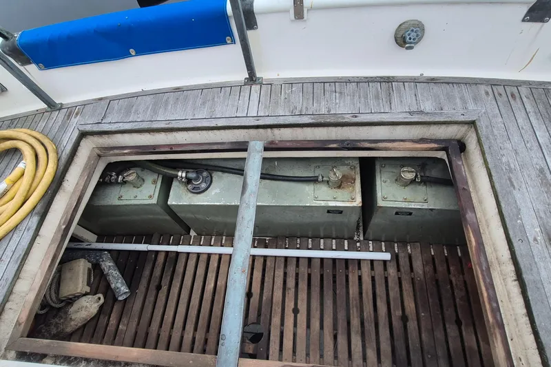 Burnin Daylight Yacht Photos Pics 1983 Grand Banks 42 Classic engine compartment with fuel tanks and hoses visible.