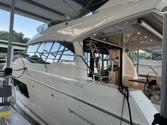 Velkommen Yacht Photos Pics 2022 Prestige 460F yacht docked under a covered marina.