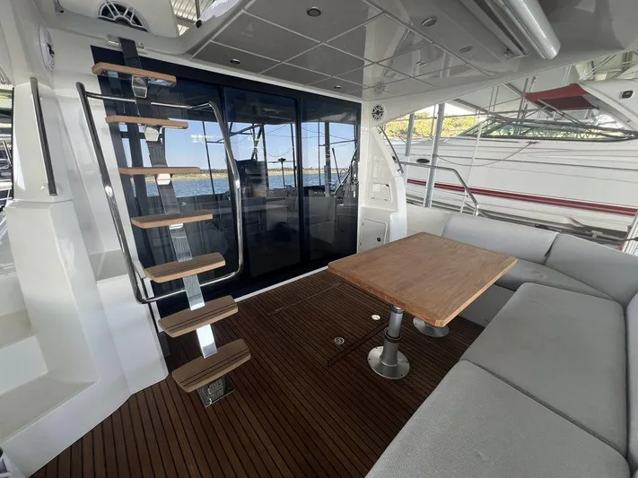 Velkommen Yacht Photos Pics Luxurious 2022 Prestige 460F yacht interior with wooden deck and modern seating area.