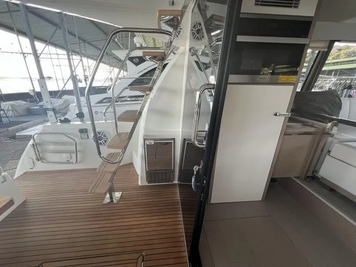 Velkommen Yacht Photos Pics Interior view of 2022 Prestige 460F yacht with wooden deck and modern design.