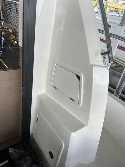 Velkommen Yacht Photos Pics Interior view of 2022 Prestige 460F yacht, featuring sleek white paneling and modern design elements.