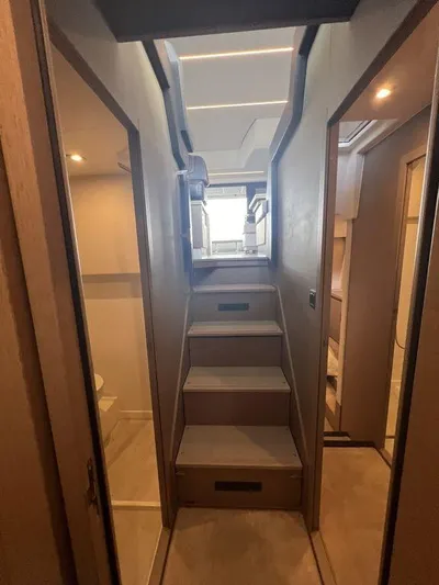 Velkommen Yacht Photos Pics Interior of 2022 Prestige 460F yacht, featuring modern staircase and elegant wood finishes.