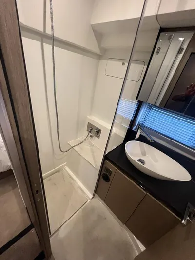 Velkommen Yacht Photos Pics Modern bathroom in 2022 Prestige 460F yacht with sleek sink and shower area.