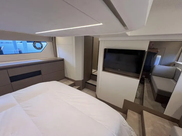 Velkommen Yacht Photos Pics Luxurious interior of 2022 Prestige 460F yacht with modern bedroom and TV.