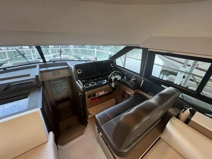 Velkommen Yacht Photos Pics Interior of 2022 Prestige 460F yacht, featuring modern helm and seating area.