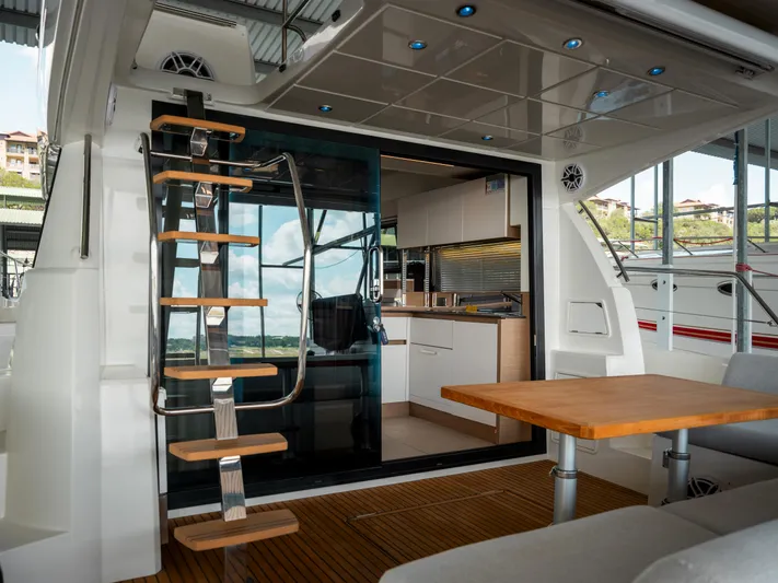 Velkommen Yacht Photos Pics Interior view of 2022 Prestige 460F yacht with modern kitchen and wooden accents.