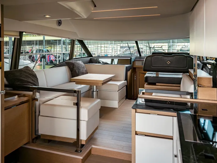 Velkommen Yacht Photos Pics Luxurious interior of 2022 Prestige 460F yacht with modern seating and dining area.