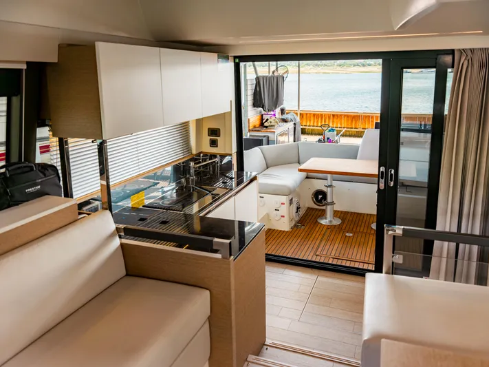 Velkommen Yacht Photos Pics Luxurious interior of 2022 Prestige 460F yacht with modern kitchen and seating area.