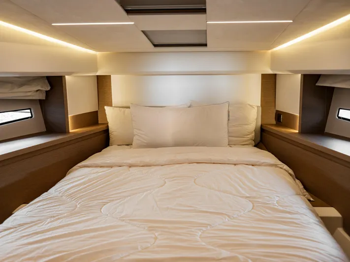 Velkommen Yacht Photos Pics Luxurious bedroom interior of 2022 Prestige 460F yacht with modern lighting and cozy bedding.