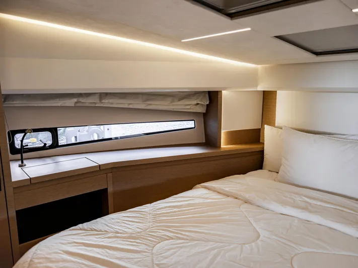 Velkommen Yacht Photos Pics Luxurious bedroom interior of 2022 Prestige 460F yacht with modern lighting and cozy bedding.