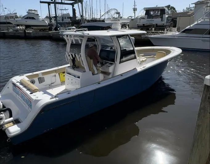  Yacht Photos Pics 2023 Sportsman boat docked at marina with other vessels in background.