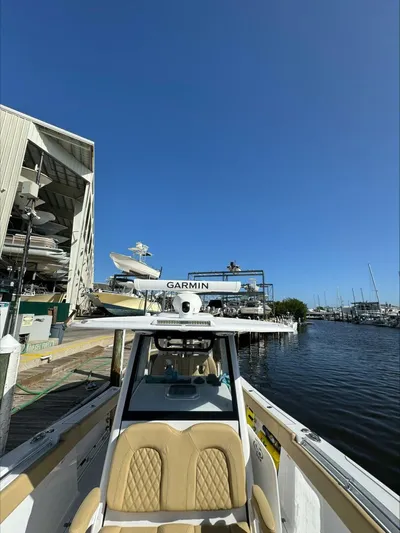  Yacht Photos Pics 2023 Sportsman boat docked near marina with clear blue sky.