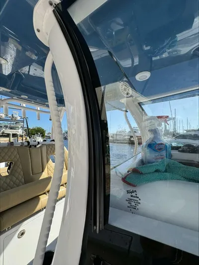  Yacht Photos Pics Interior of a 2023 Sportsman boat with cleaning supplies and marina view.