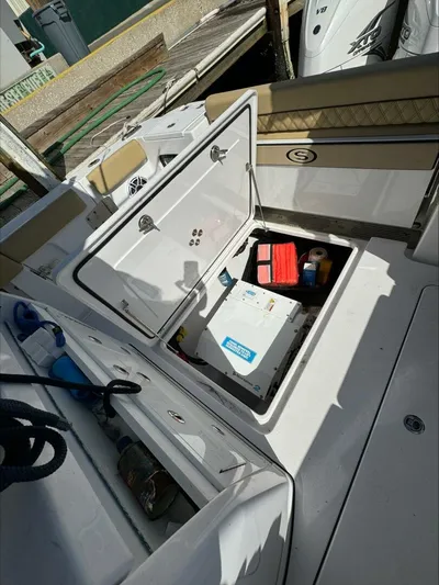  Yacht Photos Pics Open storage compartment on a 2023 Sportsman boat, revealing equipment and supplies.
