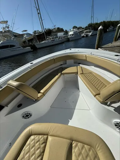  Yacht Photos Pics 2023 Sportsman boat interior with tan seating, docked at marina.