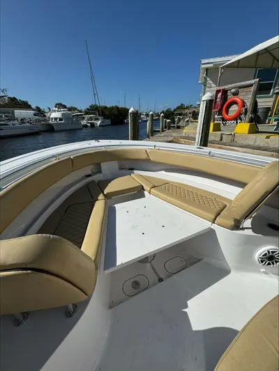  Yacht Photos Pics Bow seating area of a 2023 Sportsman boat docked at a marina.