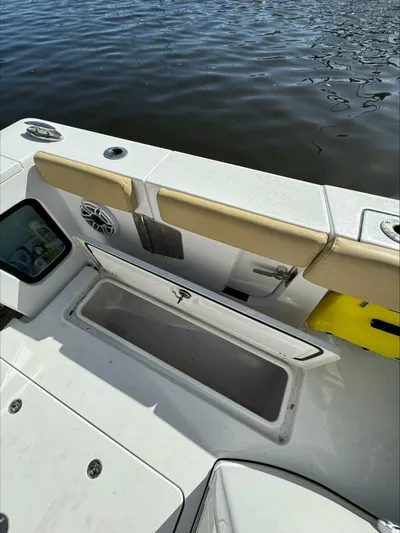  Yacht Photos Pics Open storage compartment on a 2023 Sportsman boat, near water.