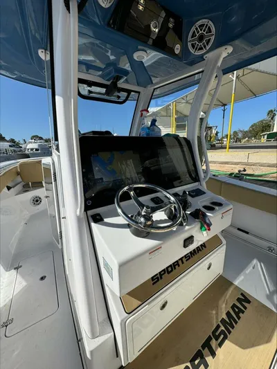  Yacht Photos Pics 2023 Sportsman boat cockpit with steering wheel and navigation system.