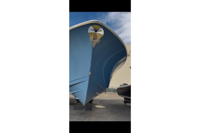  Yacht Photos Pics 2023 Sportsman Open 322 Center Console boat, blue hull, docked outdoors.