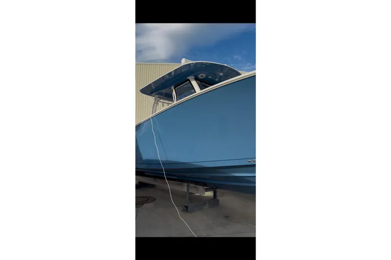  Yacht Photos Pics 2023 Sportsman Open 322 Center Console boat in blue, docked outdoors.