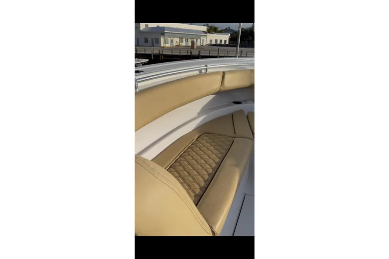  Yacht Photos Pics 2023 Sportsman Open 322 Center Console boat with tan cushioned seating.