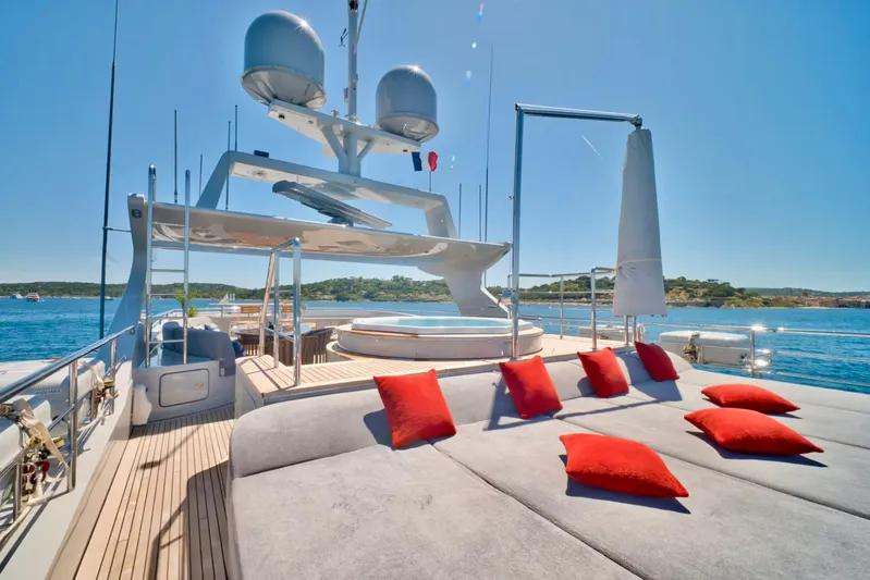  Yacht Photos Pics Luxurious 2007 Baglietto 43 yacht deck with sun loungers and vibrant red cushions.