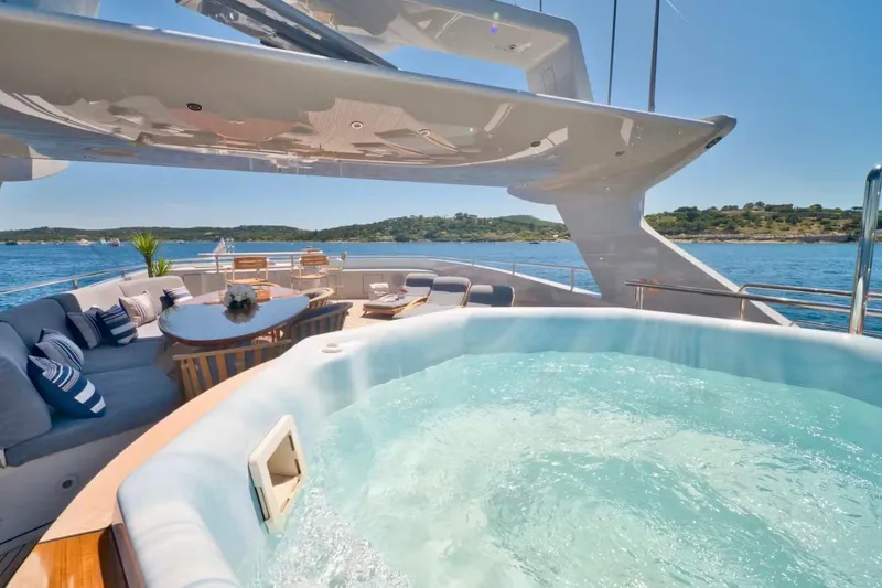  Yacht Photos Pics Luxurious 2007 Baglietto 43 yacht deck with jacuzzi and seating area, ocean view.