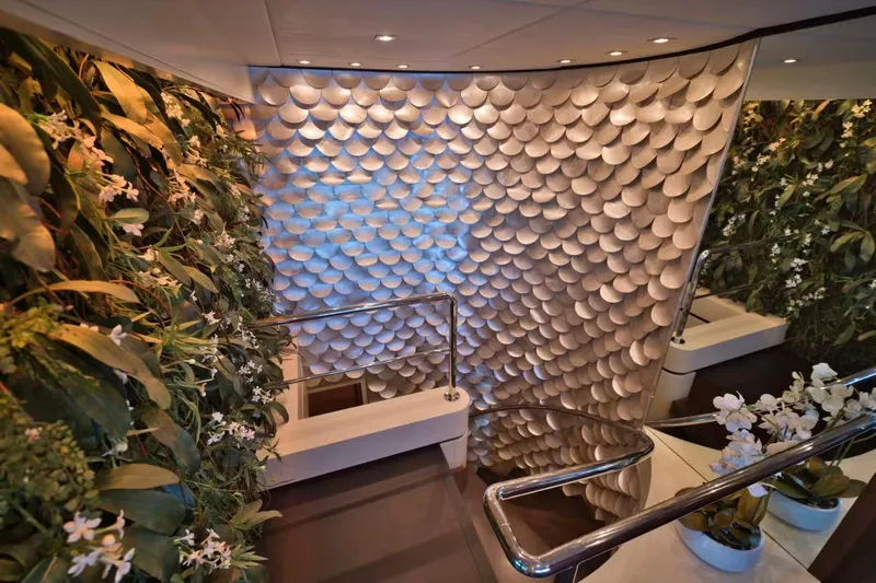  Yacht Photos Pics Luxurious interior of 2007 Baglietto 43 yacht with elegant staircase and lush greenery.