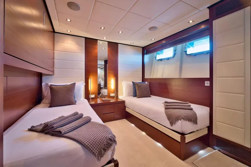  Yacht Photos Pics Luxurious twin cabin interior on 2007 Baglietto 43 yacht, featuring elegant wood paneling and cozy bedding.