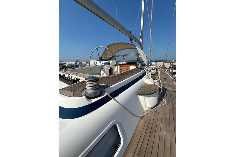 Magic I Yacht Photos Pics Deck view of 2021 Hallberg-Rassy 44 sailboat with wooden finish and steering wheel.