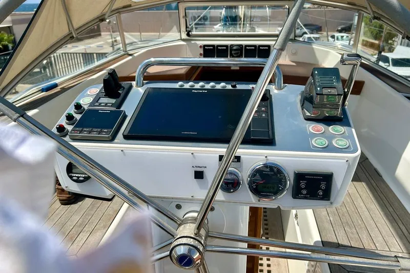 Magic I Yacht Photos Pics Cockpit of 2021 Hallberg-Rassy 44 sailboat with navigation instruments and steering wheel.