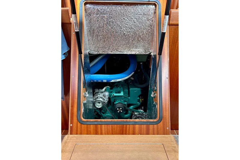 Magic I Yacht Photos Pics Engine compartment of a 2021 Hallberg-Rassy 44 sailboat, showcasing mechanical components.