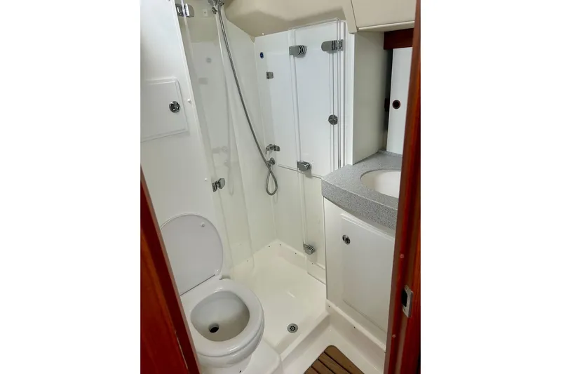Magic I Yacht Photos Pics Bathroom interior of 2021 Hallberg-Rassy 44 yacht, featuring shower and toilet.