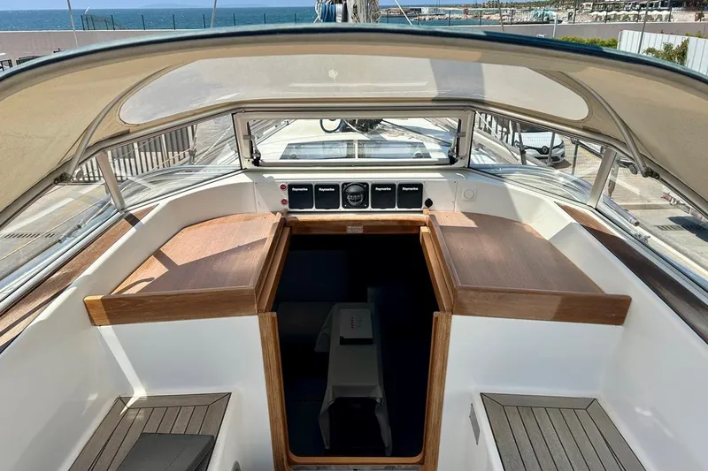 Magic I Yacht Photos Pics Interior view of 2021 Hallberg-Rassy 44 yacht cockpit with wooden accents and navigation instruments.