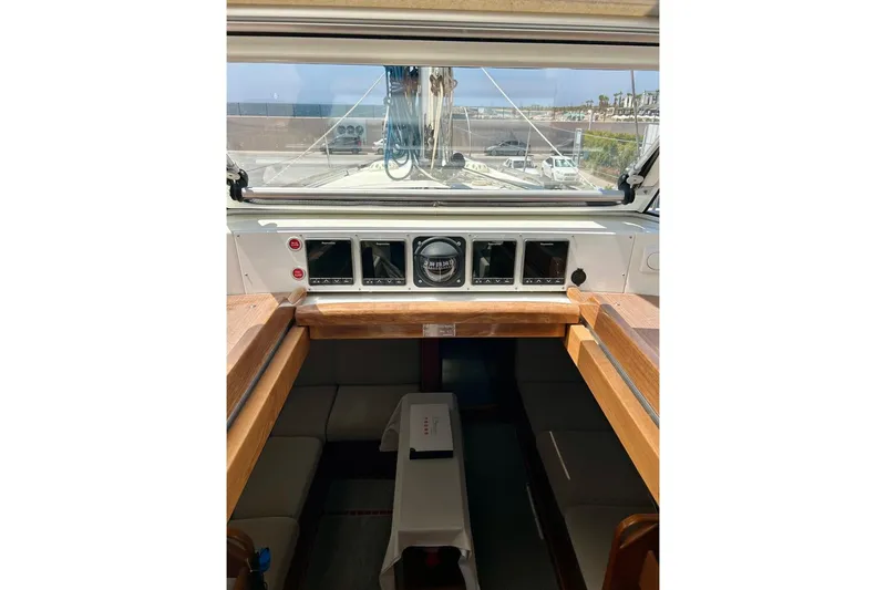 Magic I Yacht Photos Pics Interior view of 2021 Hallberg-Rassy 44 sailboat cockpit with navigation instruments.