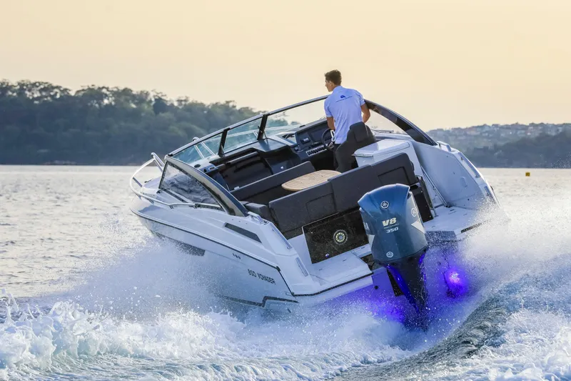  Yacht Photos Pics 2024 Skamander 850 Voyager boat cruising on water with outboard motor.