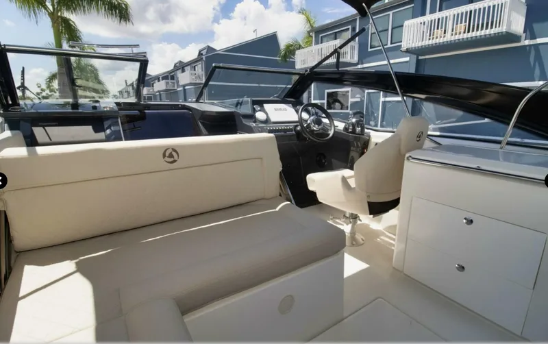  Yacht Photos Pics 2024 Skamander 850 Voyager boat interior with modern seating and steering console.