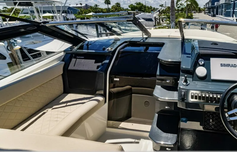  Yacht Photos Pics 2024 Skamander 850 Voyager boat interior with modern dashboard and seating.