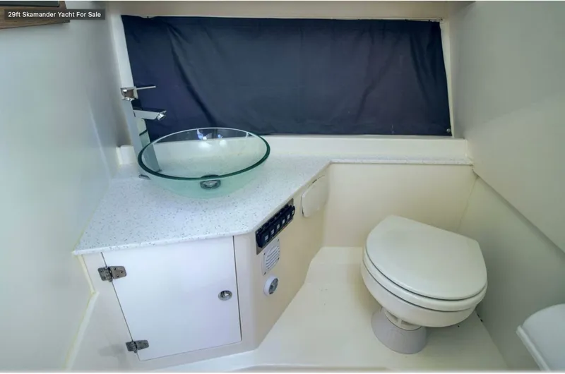  Yacht Photos Pics Modern bathroom in 2024 Skamander 850 Voyager yacht with glass sink and toilet.