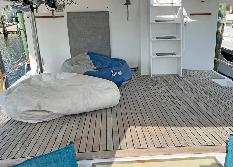  Yacht Photos Pics 1987 DeFever Tri-Cabin deck with bean bags and ladder, featuring wooden flooring.