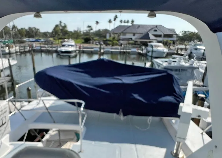  Yacht Photos Pics 1987 DeFever Tri-Cabin yacht docked at marina, covered deck, surrounded by boats.