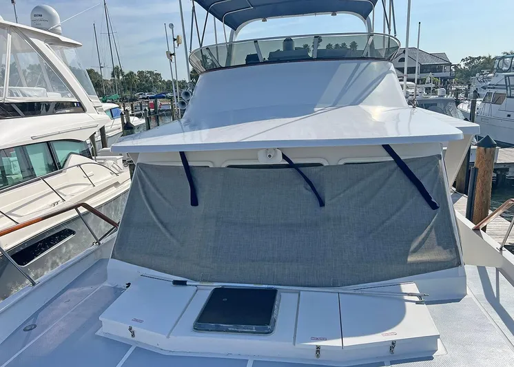  Yacht Photos Pics 1987 DeFever Tri-Cabin yacht docked at marina, featuring covered deck and sleek design.