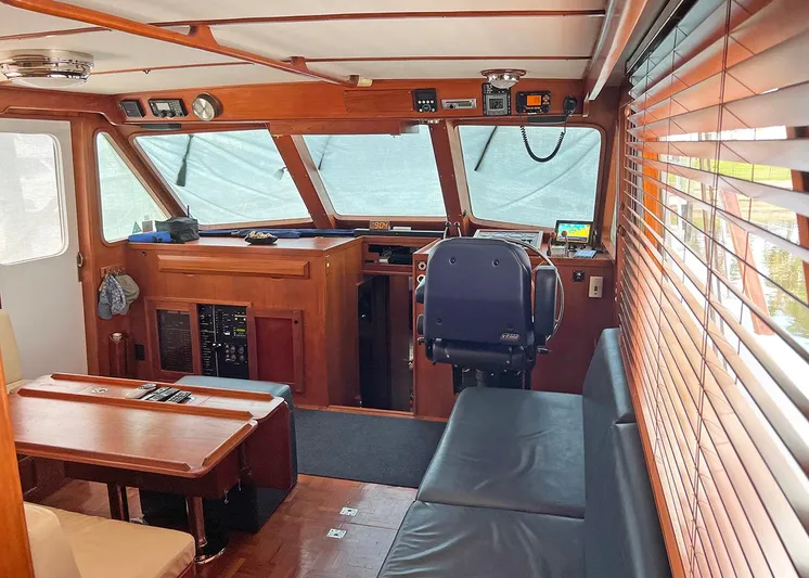  Yacht Photos Pics 1987 DeFever Tri-Cabin interior with wooden paneling, seating, and navigation area.