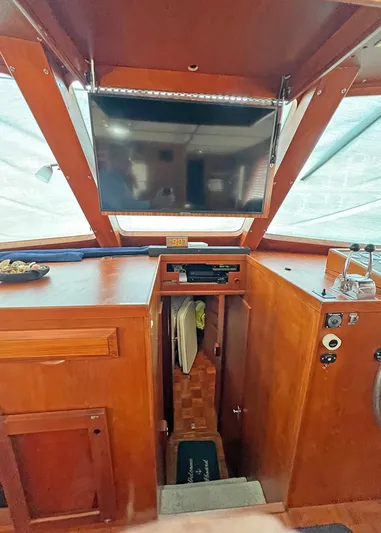  Yacht Photos Pics 1987 DeFever Tri-Cabin interior with wood finish and mounted TV.