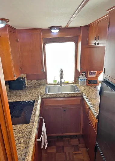  Yacht Photos Pics 1987 DeFever Tri-Cabin kitchen with granite countertops and wooden cabinetry.