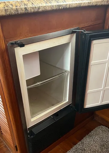  Yacht Photos Pics Open refrigerator in 1987 DeFever Tri-Cabin yacht, showcasing interior storage space.