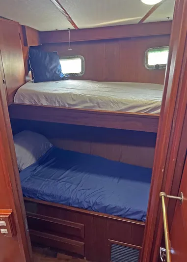  Yacht Photos Pics 1987 DeFever Tri-Cabin interior with wooden bunk beds and small windows.
